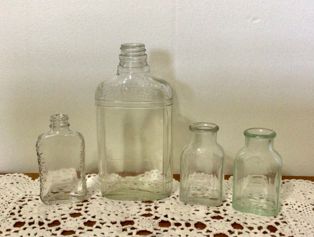 Four Vintage Clear Glass Bottles